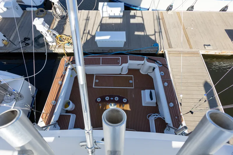 Slide: The Image of 2005 Luhrs 36 boat deck with wooden flooring, docked at a marina. - 15