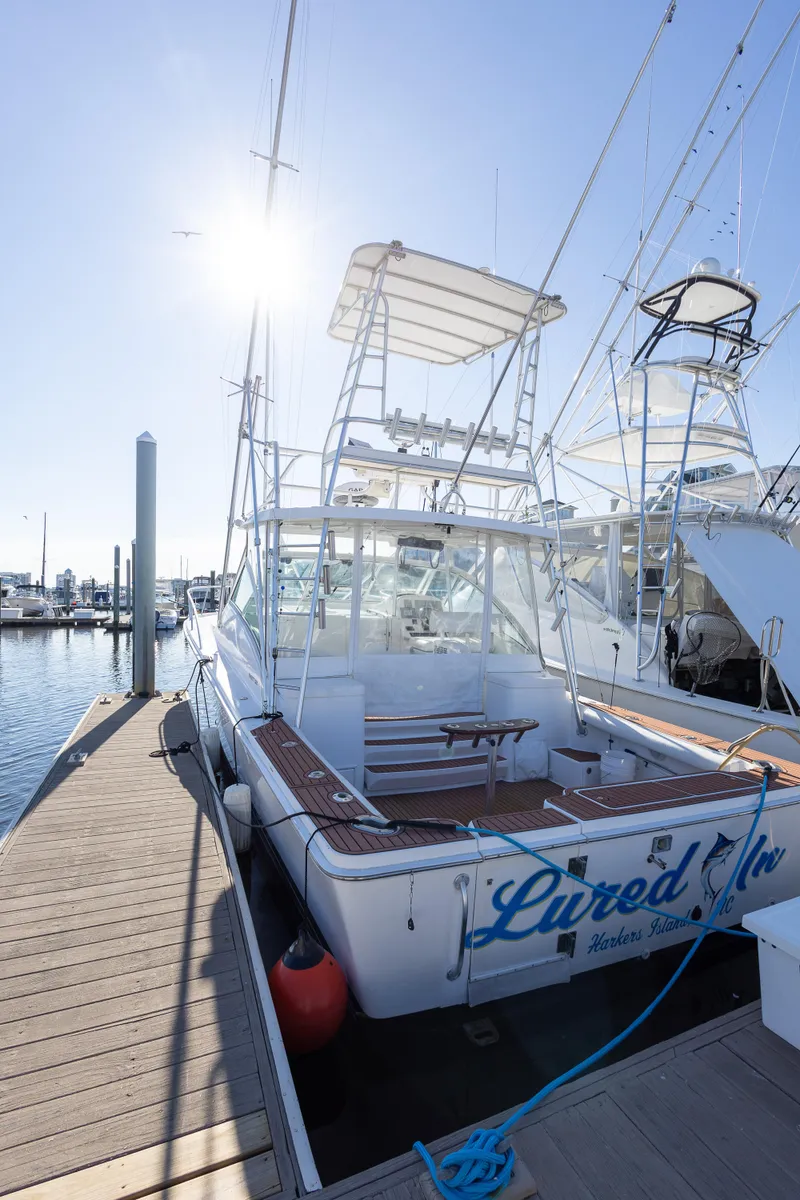 Slide: The Image of 2005 Luhrs 36 boat docked at marina under clear sky. - 22