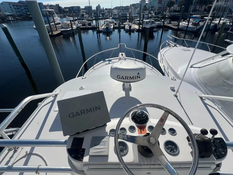 Slide: The Image of Helm of 2005 Luhrs 36 boat with Garmin navigation, docked at marina. - 27