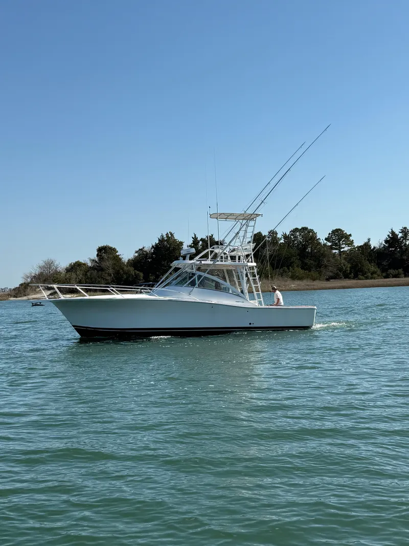 Slide: The Image of 2005 Luhrs 36 boat cruising on calm water under clear blue sky. - 3
