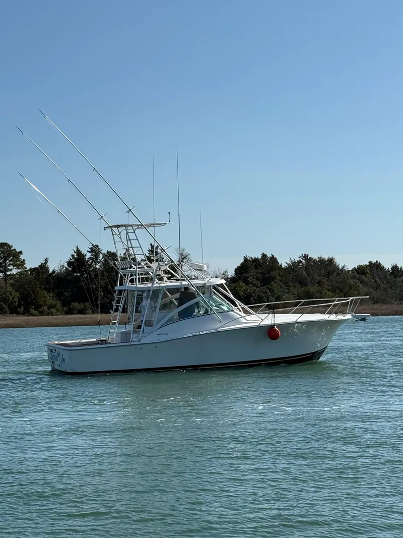 Slide: The Image of 2005 Luhrs 36 boat on calm water with clear sky background. - 7