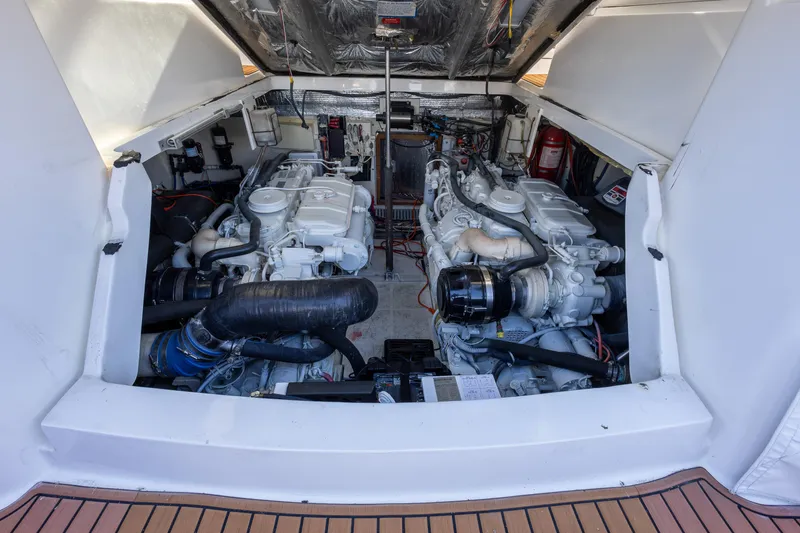 Slide: The Image of Engine compartment of a 2005 Luhrs 36 boat, showcasing dual engines and mechanical components. - 9