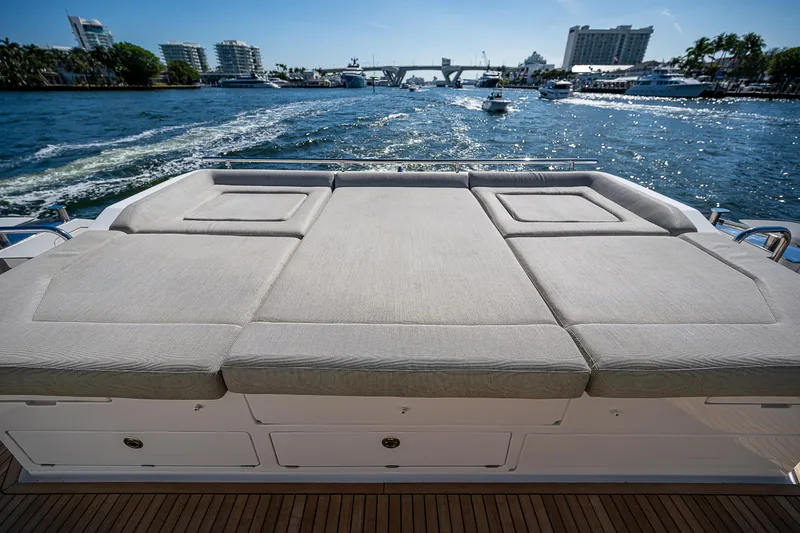 Slide: The Image of 2019 Azimut S7 yacht with sunbed, cruising on a sunny day, scenic waterfront view. - 17