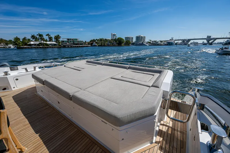 Slide: The Image of 2019 Azimut S7 yacht with sunbed, cruising on a sunny day, scenic waterfront view. - 18