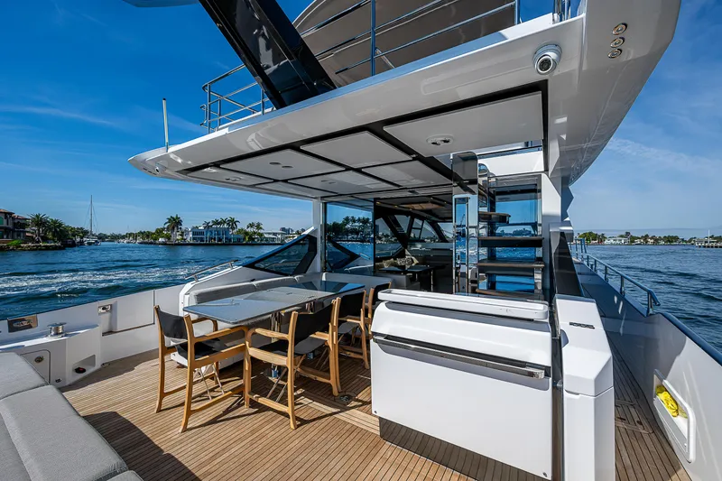 Slide: The Image of 2019 Azimut S7 yacht with outdoor dining area and scenic water view. - 20