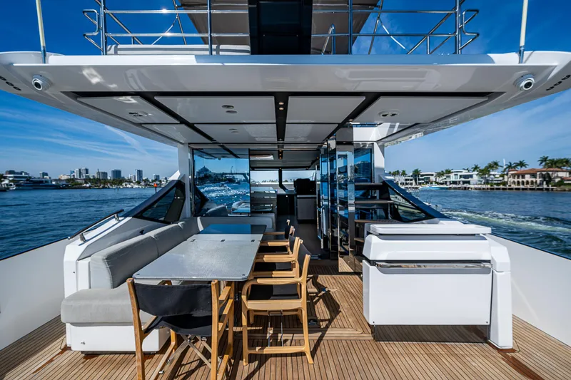 Slide: The Image of Luxurious 2019 Azimut S7 yacht deck with dining area, overlooking serene waterfront views. - 22