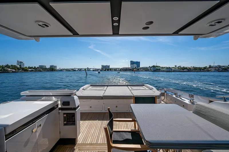 Slide: The Image of 2019 Azimut S7 yacht deck with ocean view, featuring dining area and modern amenities. - 24