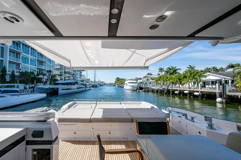 Slide: The Image of Luxurious 2019 Azimut S7 yacht docked in a scenic marina with modern amenities. - 25