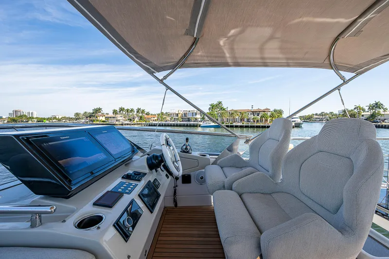 Slide: The Image of 2019 Azimut S7 yacht cockpit with plush seating and scenic waterfront view. - 32