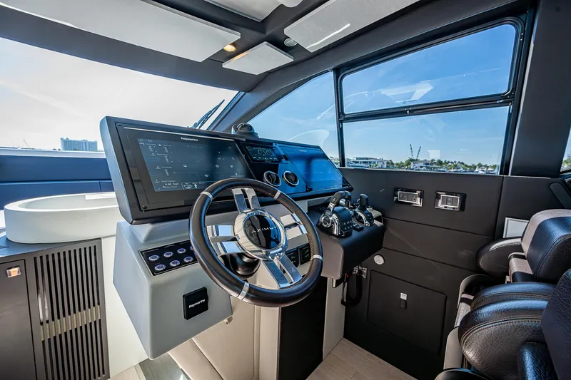 Slide: The Image of 2019 Azimut S7 yacht cockpit with modern steering wheel and advanced navigation systems. - 42