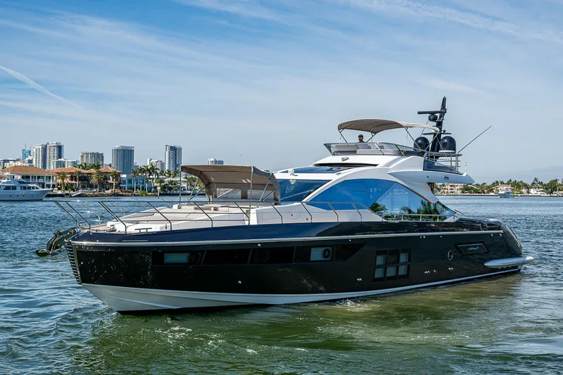 Slide: The Image of 2019 Azimut S7 yacht cruising on water with city skyline in background. - 5