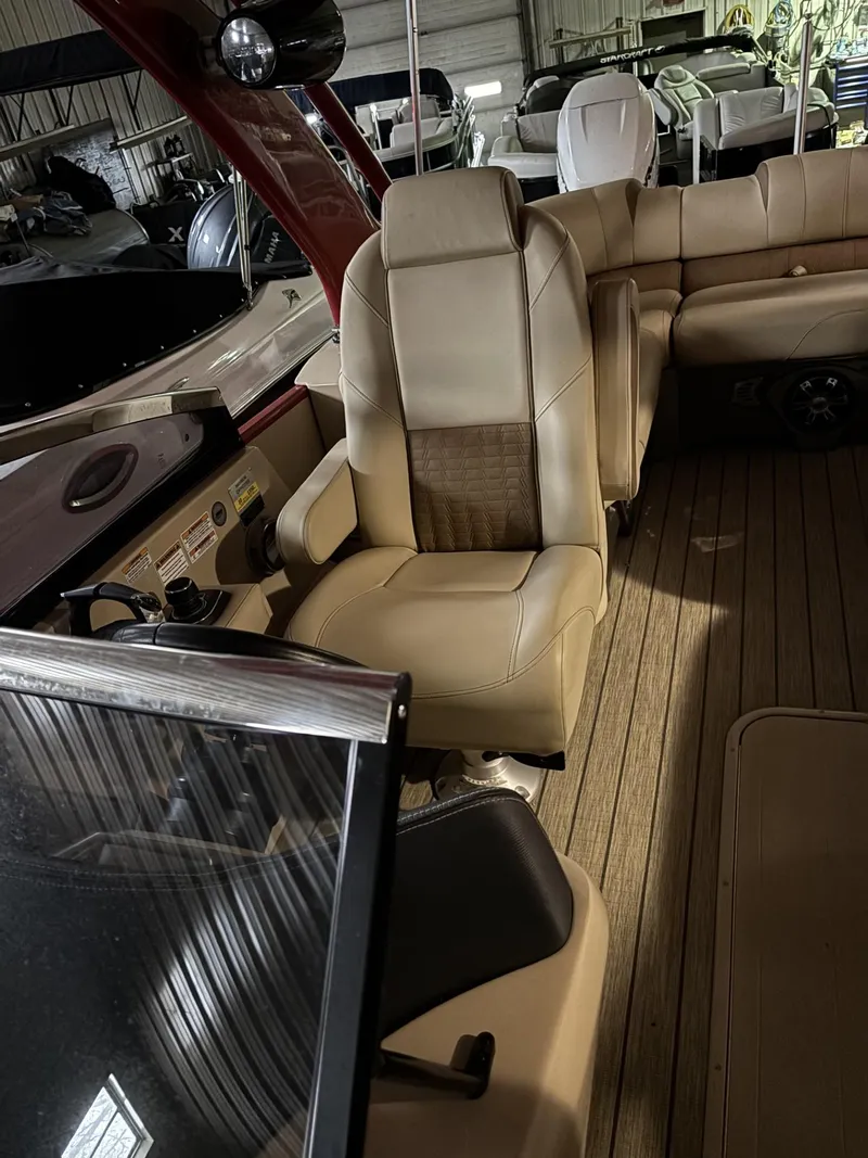Slide: The Image of Luxurious interior of 2022 Avalon Excalibur Elite Windshield boat with plush seating. - 20