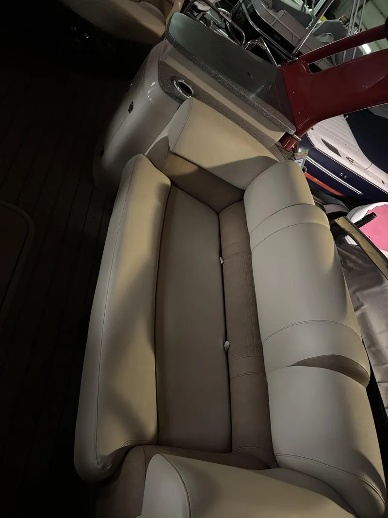 Slide: The Image of 2022 Avalon Excalibur Elite Windshield boat interior with beige seating and sleek design. - 21