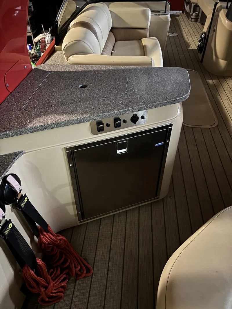 Slide: The Image of 2022 Avalon Excalibur Elite Windshield interior with seating and kitchenette area. - 25