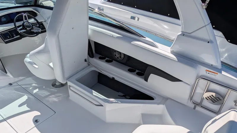 Slide: The Image of 2025 Four Winns HD8 OB boat interior with seating, storage, and steering wheel. - 10