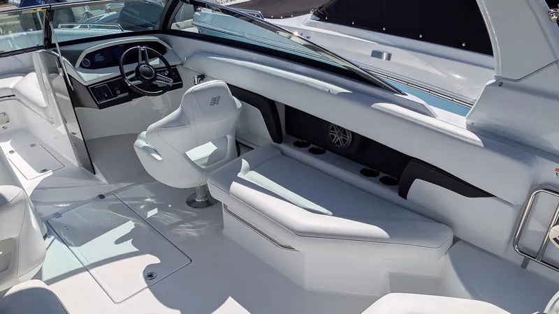 Slide: The Image of 2025 Four Winns HD8 OB boat interior with sleek white seating and modern dashboard. - 11