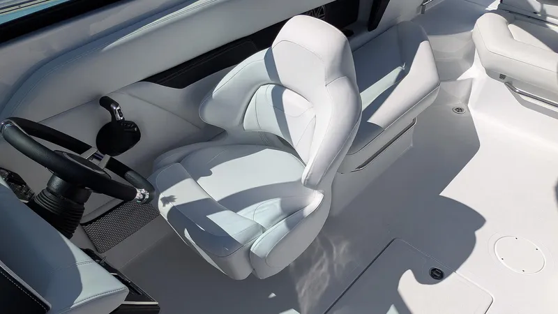 Slide: The Image of 2025 Four Winns HD8 OB boat interior with sleek white seating and modern steering wheel. - 12