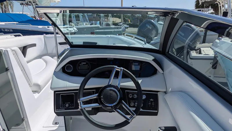 Slide: The Image of 2025 Four Winns HD8 OB boat cockpit with modern steering and dashboard controls. - 13