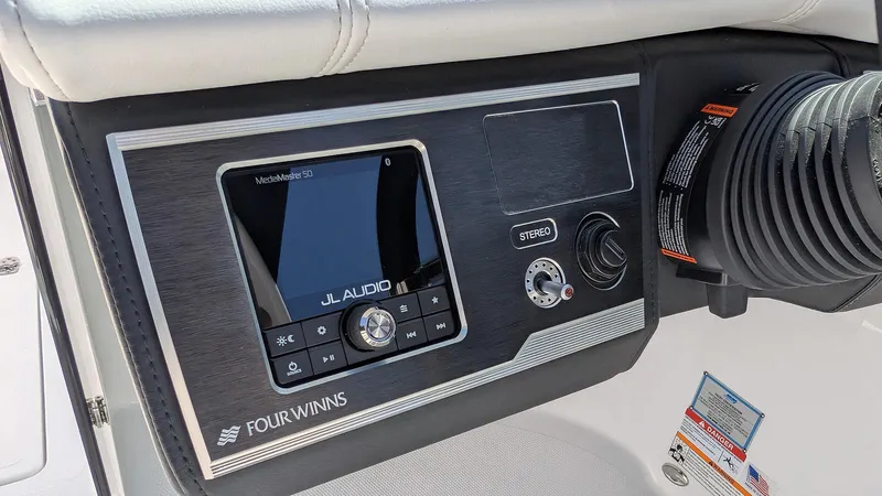 Slide: The Image of Control panel of 2025 Four Winns HD8 OB boat featuring JL Audio system. - 15