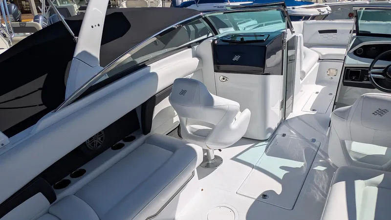 Slide: The Image of 2025 Four Winns HD8 OB boat interior with white seating and modern design. - 16