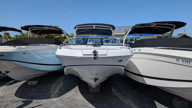 Slide: The Image of 2025 Four Winns HD8 OB boats displayed in a row under clear blue skies. - 2