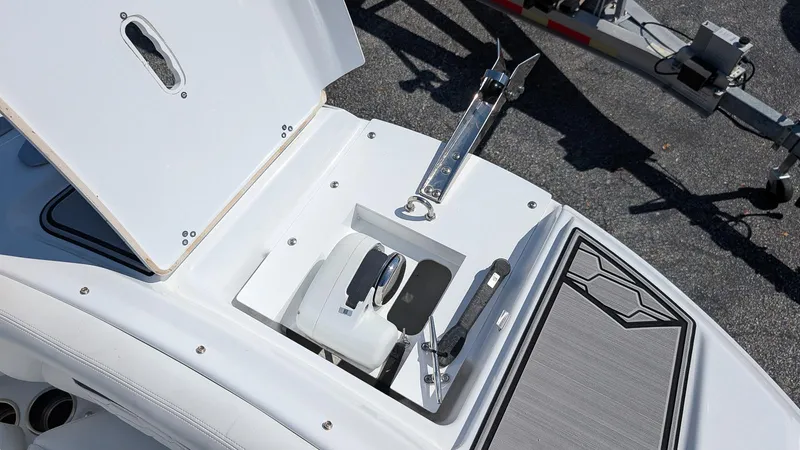 Slide: The Image of 2025 Four Winns HD8 OB boat anchor compartment with open hatch, showcasing sleek design. - 24