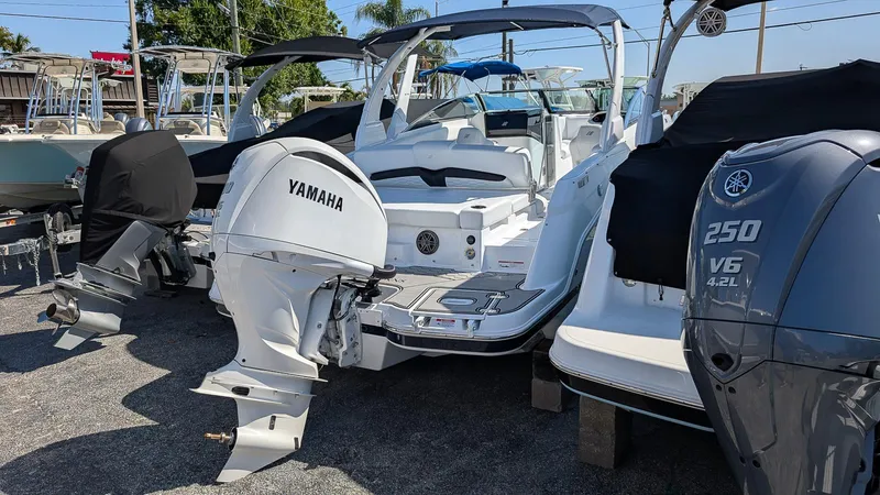 Slide: The Image of 2025 Four Winns HD8 OB boat with Yamaha outboard motor in a marina. - 3