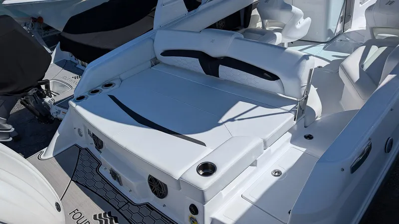 Slide: The Image of 2025 Four Winns HD8 OB boat with white seating and sleek design. - 6