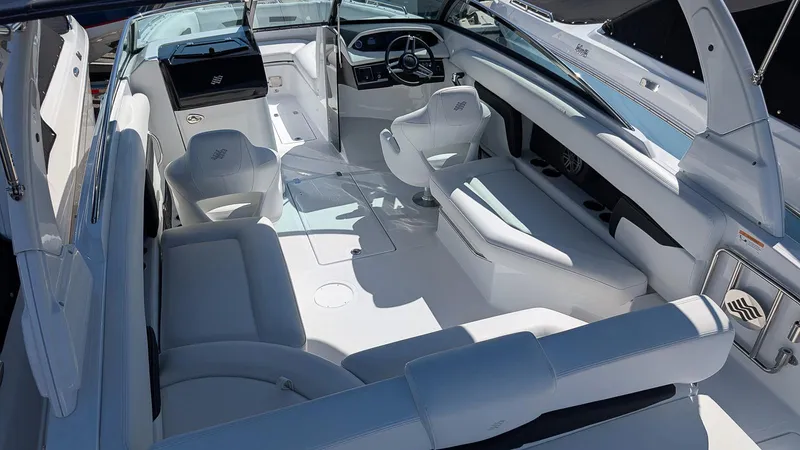 Slide: The Image of 2025 Four Winns HD8 OB boat interior with white seating and modern dashboard. - 7