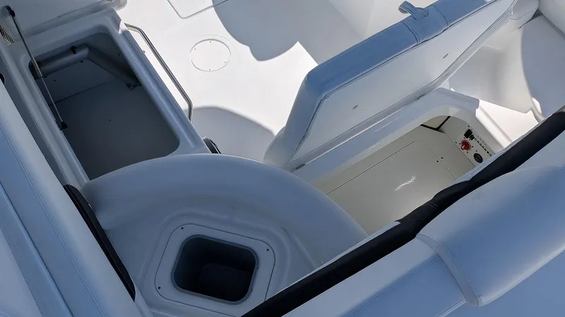 Slide: The Image of 2025 Four Winns HD8 OB boat interior with storage compartments and seating. - 9