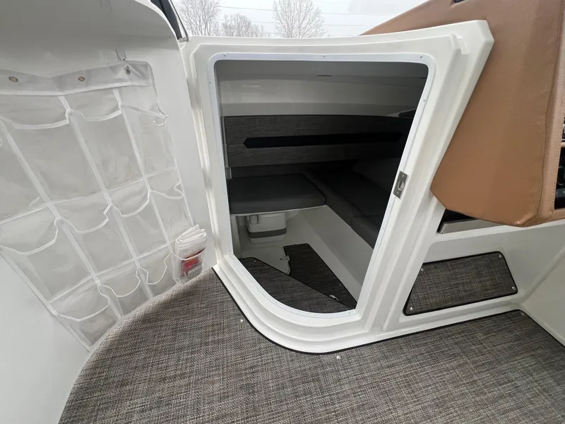 Slide: The Image of 2023 Cobalt A29 boat cabin interior with storage pockets and seating area. - 12