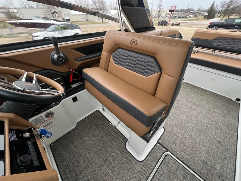 Slide: The Image of 2023 Cobalt A29 boat interior with tan leather seating and modern dashboard. - 19