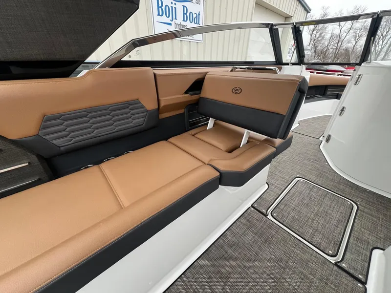 Slide: The Image of 2023 Cobalt A29 boat interior with tan and black seating, modern design. - 23