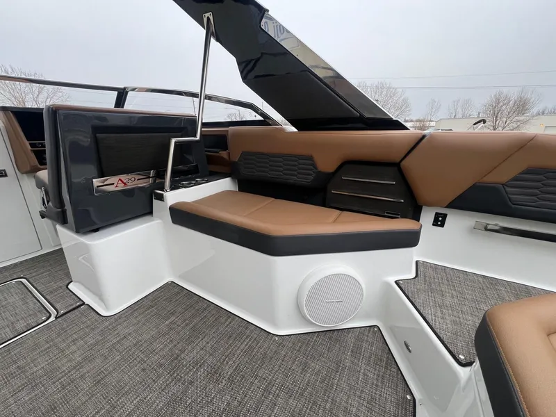 Slide: The Image of 2023 Cobalt A29 boat interior with brown seating and modern design elements. - 24