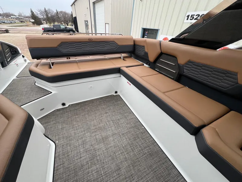 Slide: The Image of 2023 Cobalt A29 boat interior with brown and black seating, modern design. - 25