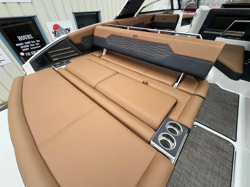 Slide: The Image of 2023 Cobalt A29 boat interior with tan leather seating and cup holders. - 27