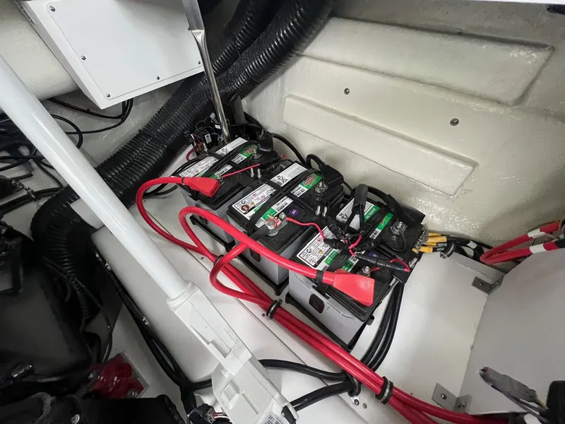 Slide: The Image of 2023 Cobalt A29 boat battery compartment with multiple batteries and wiring. - 30