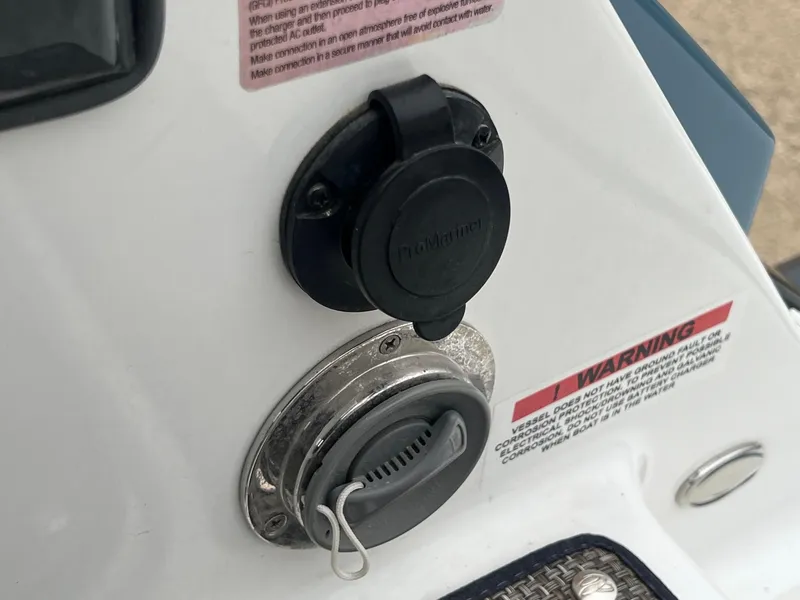 Slide: The Image of 2023 Cobalt A29 boat power outlet and warning label detail. - 37