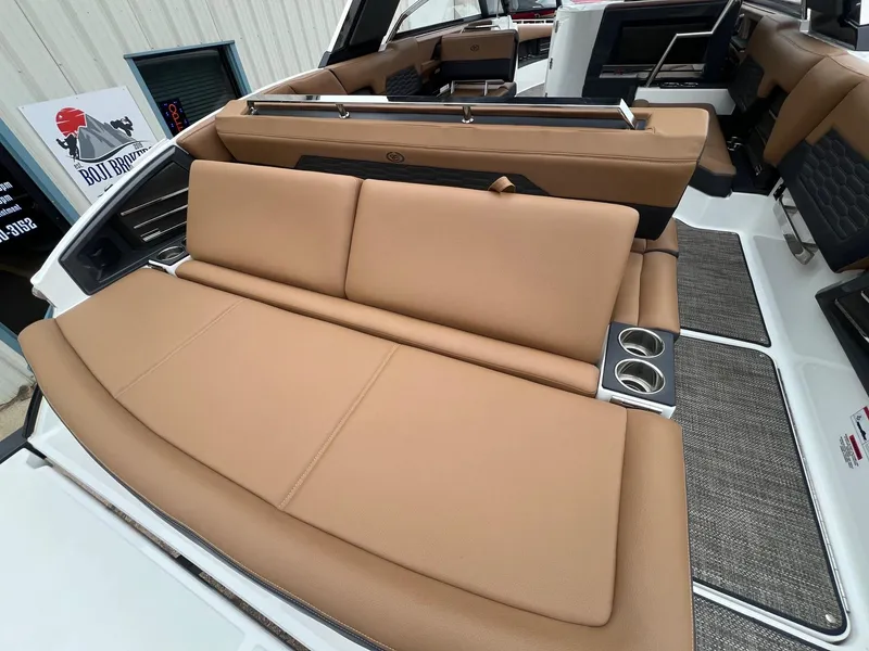Slide: The Image of 2023 Cobalt A29 boat interior with tan seating and cup holders. - 38