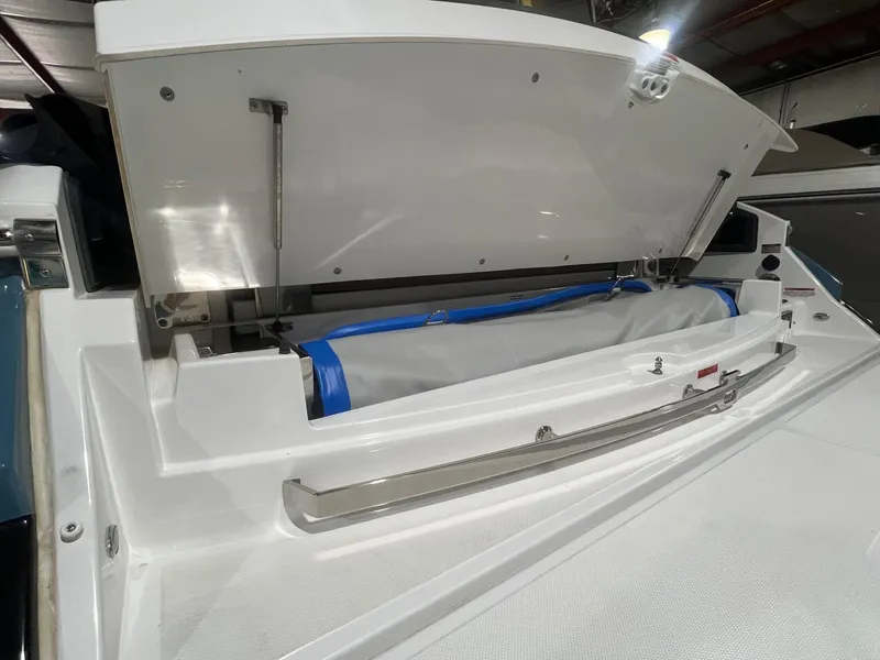 Slide: The Image of 2023 Cobalt A29 boat storage compartment with open lid, showcasing interior details. - 39