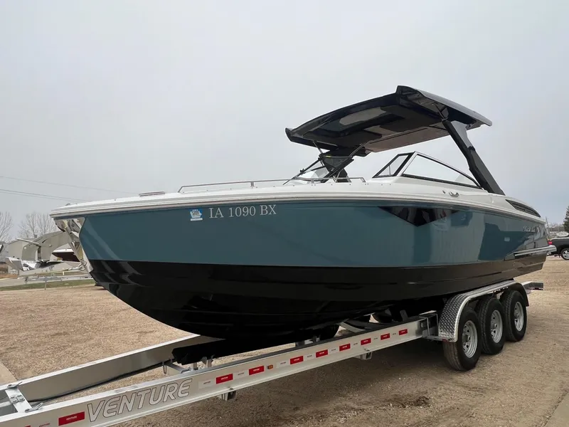 Slide: The Image of 2023 Cobalt A29 boat on trailer, sleek design, blue and black color scheme. - 4