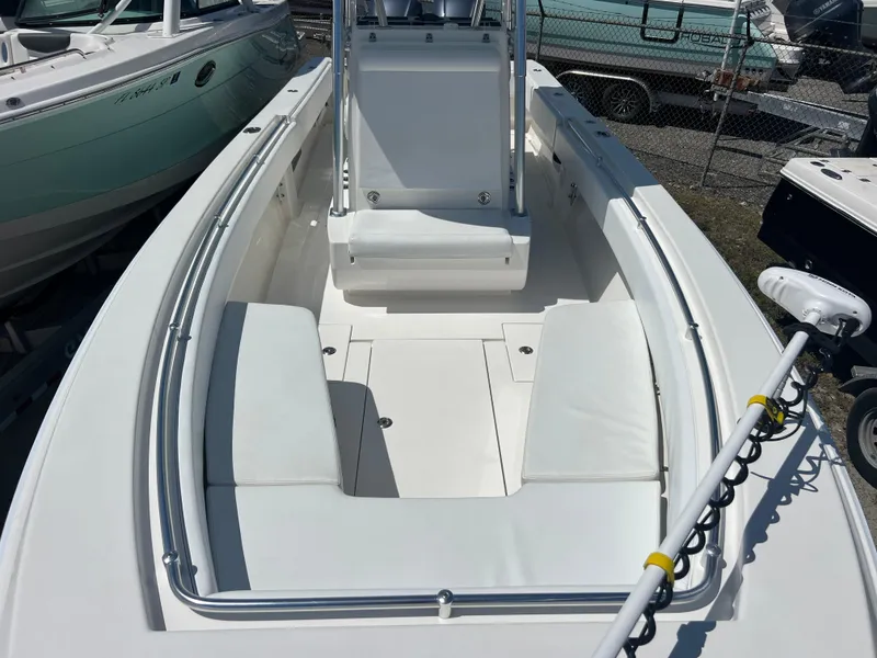 Slide: The Image of 2013 Contender 28 Sport boat interior with white seating and console. - 13