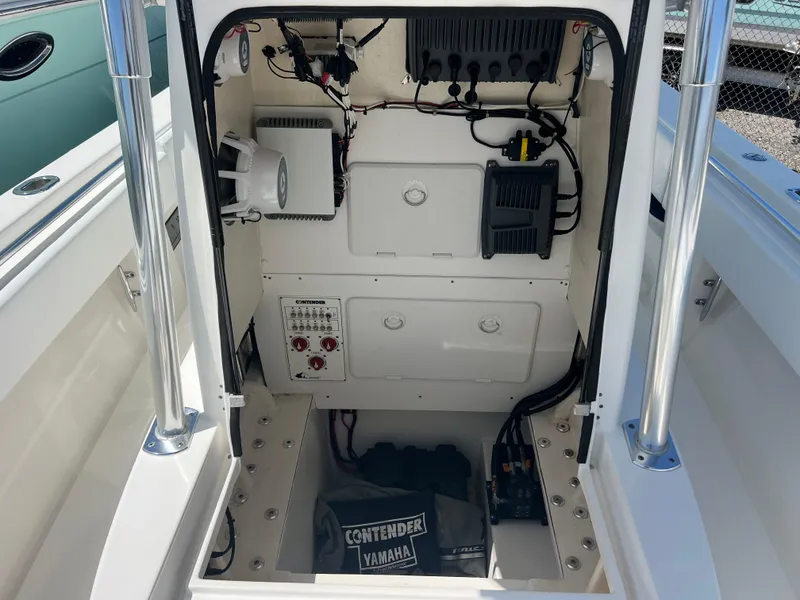 Slide: The Image of 2013 Contender 28 Sport boat console with electronic equipment and storage compartments. - 15