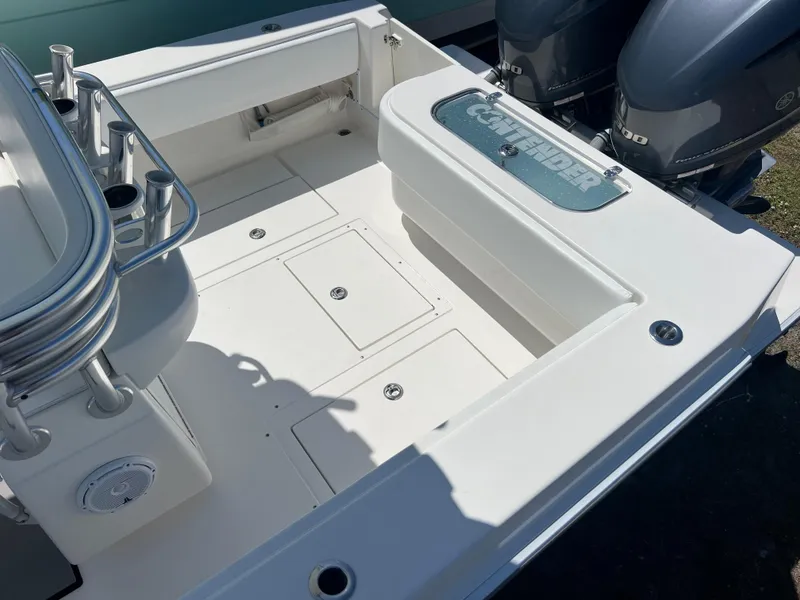 Slide: The Image of 2013 Contender 28 Sport boat deck with dual engines and storage compartments. - 17