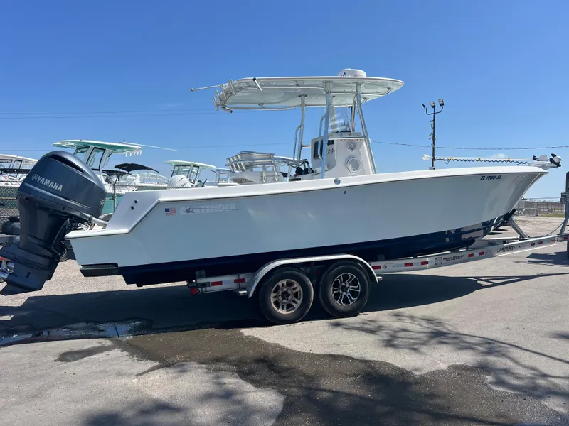 Slide: The Image of 2013 Contender 28 Sport boat on trailer, featuring Yamaha outboard motor. - 4