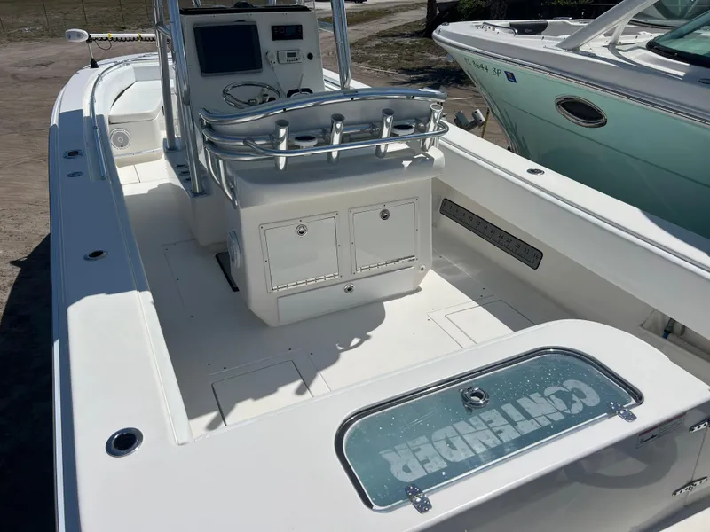 Slide: The Image of 2013 Contender 28 Sport boat interior with console and seating, showcasing sleek design and functionality. - 7