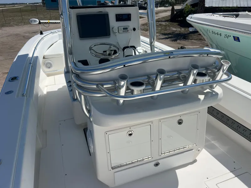 Slide: The Image of 2013 Contender 28 Sport boat interior with steering console and rod holders. - 8