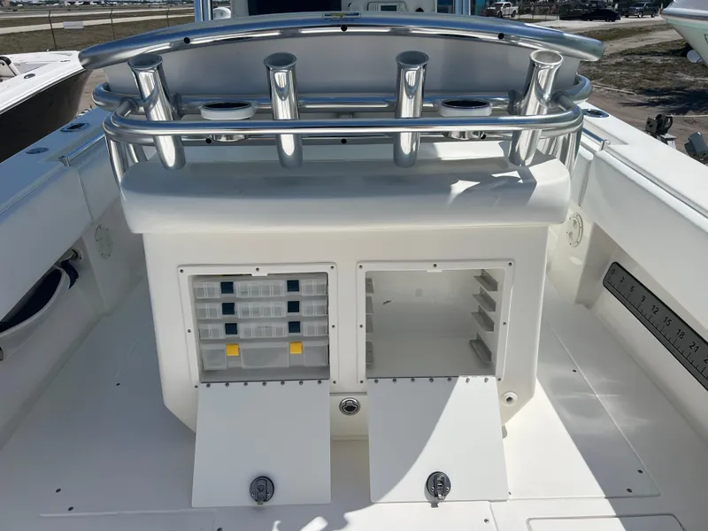 Slide: The Image of 2013 Contender 28 Sport boat with rod holders and storage compartments. - 9