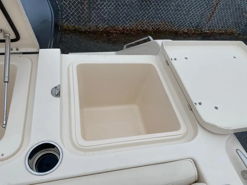 Slide: The Image of 2017 Grady-White Express 370 boat storage compartment with open lid and cup holder. - 11