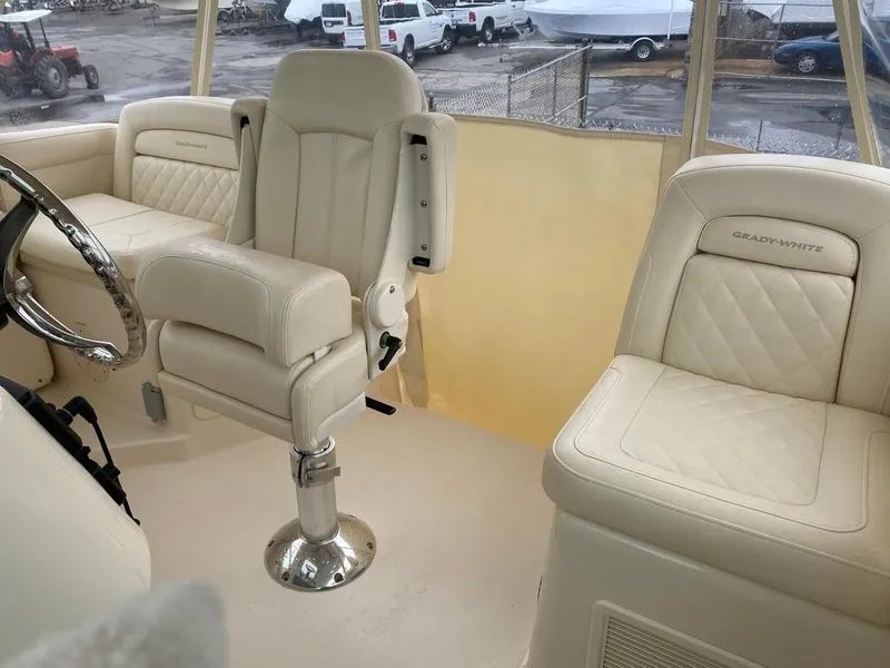 Slide: The Image of 2017 Grady-White Express 370 boat interior with cream leather seating and steering wheel. - 15